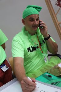 Patrick McKenna volunteering for Hole in the Wall Gang holding a phone taking calls for fundraising