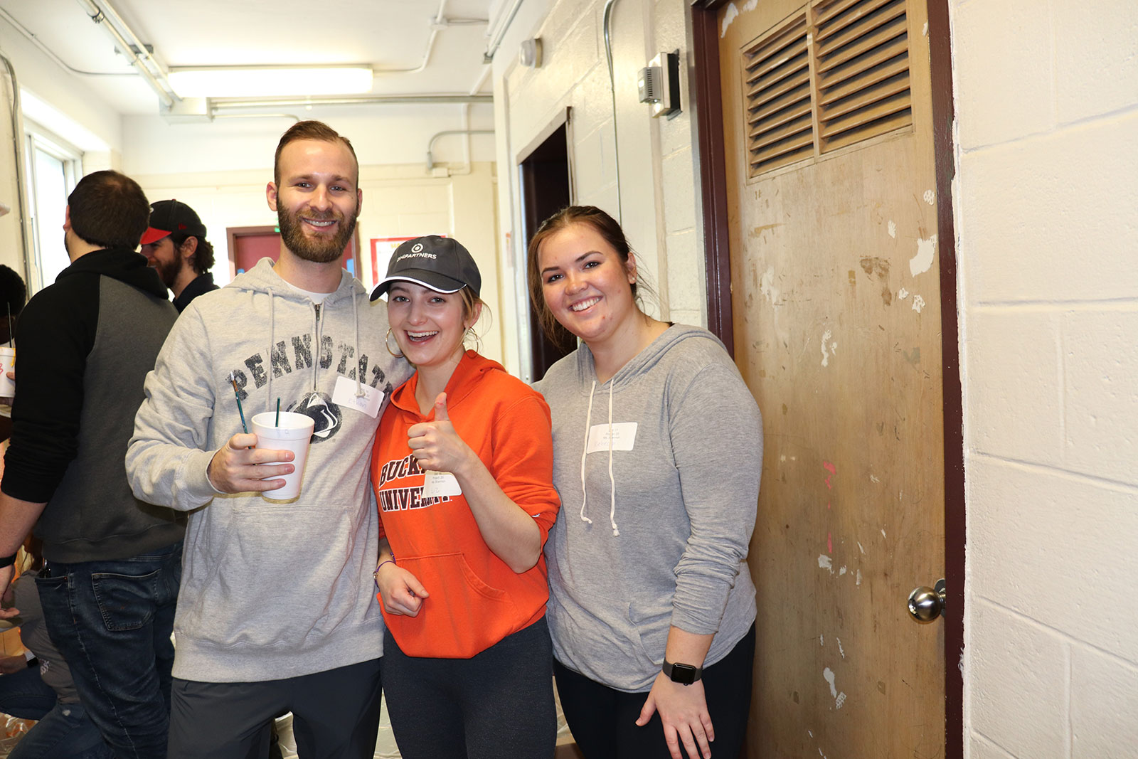 DMi MLK Day volunteering at Stephen Girard Elementary School, dmi employees huddling in the school hallway