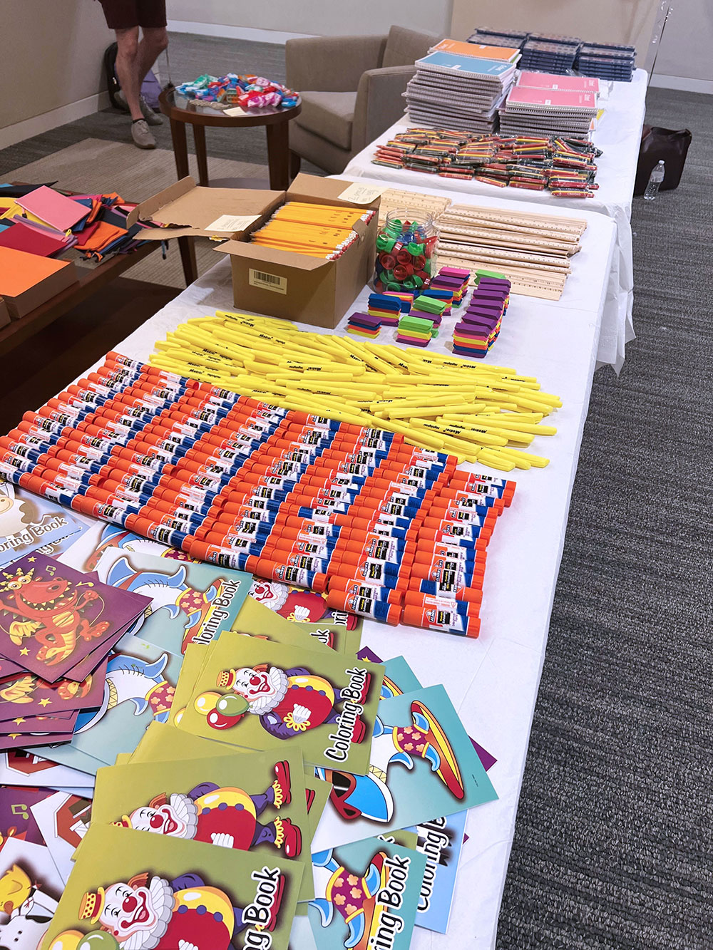 table with craft supplies, paper, markers, coloring books, for kids activities