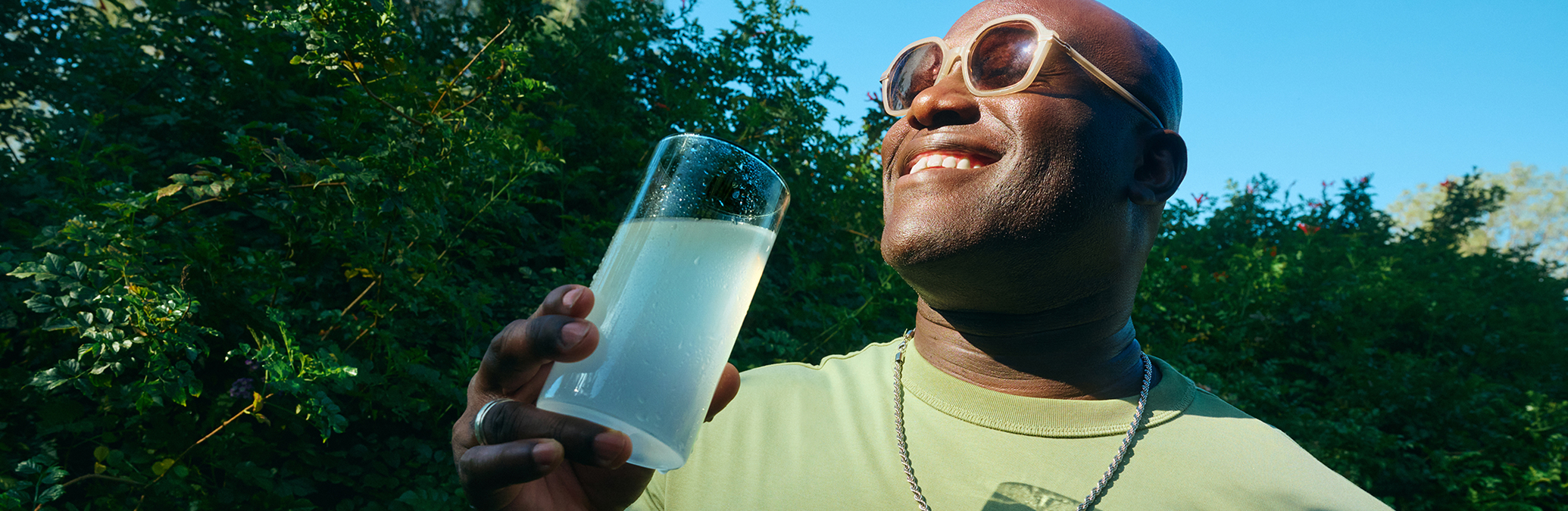 Influencer enjoying a glass of Liquid I.V. outdoors as part of a brand campaign